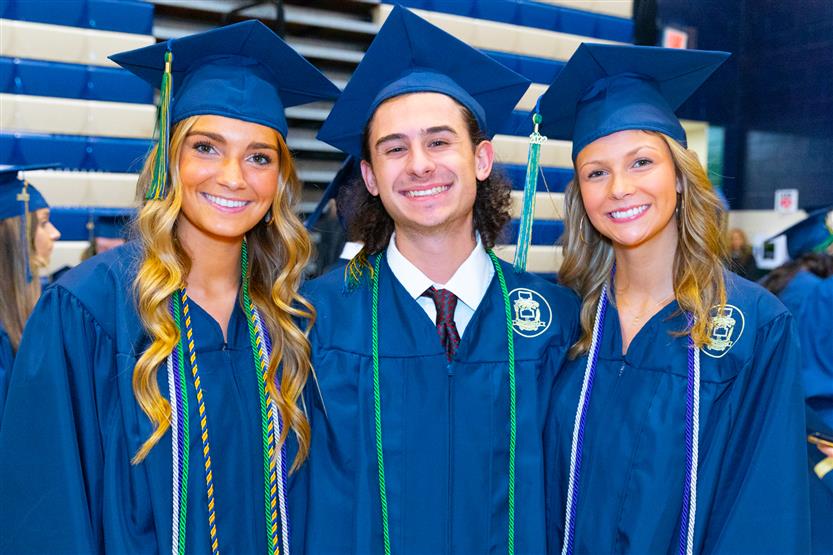 Students wearing blue graduation robes